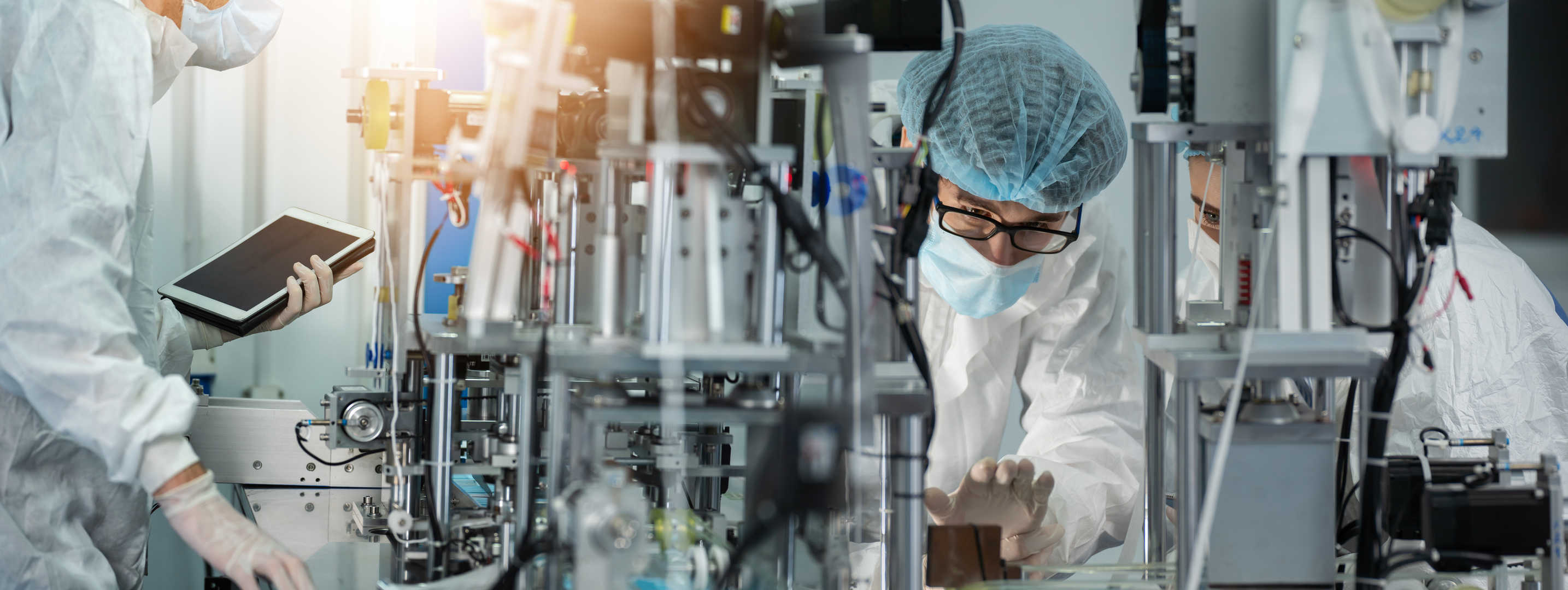 A scientist in a state-of-the-art cGMP manufacturing facility handling ADC production equipment.